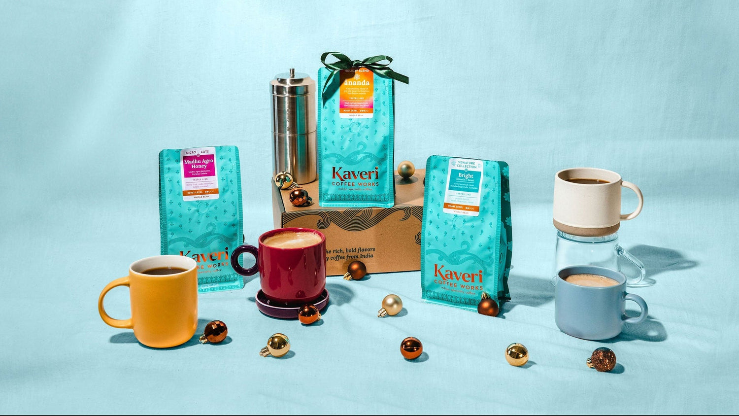 Kavert coffee products including bags, mugs, and a grinder on a light blue background