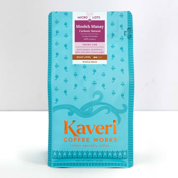 A package of Kaveri Coffee Works Mooleh Manay whole bean coffee in a bright turquoise blue bag with orange and white text, photographed against a clean white background.